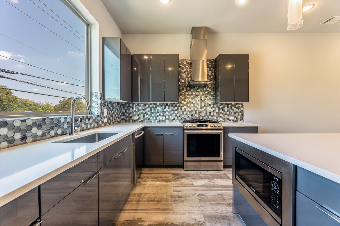 1417 Kramer Lane, Unit 9 Austin, TX 78758 - Photo 22 of 40 a large kitchen with a sink and stove