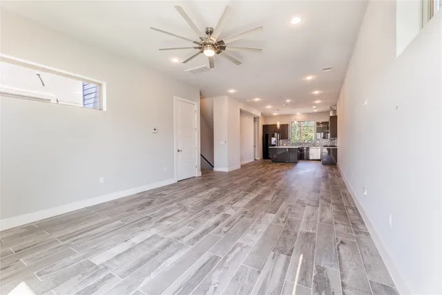 a view of a balcony with stainless steel appliances wooden floor and a window
