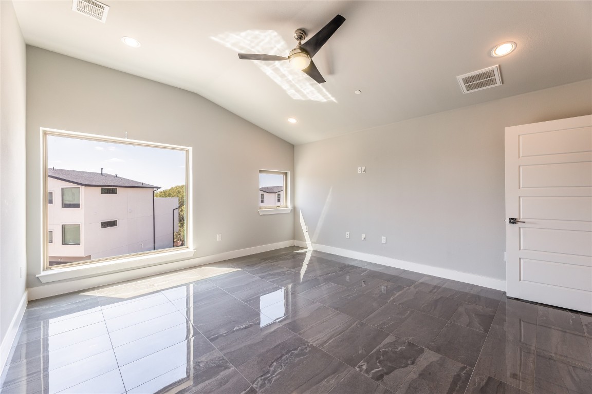 1417 Kramer Lane, Unit 9 Austin, TX 78758 - Photo 31 of 40 an empty room with wooden floor and windows