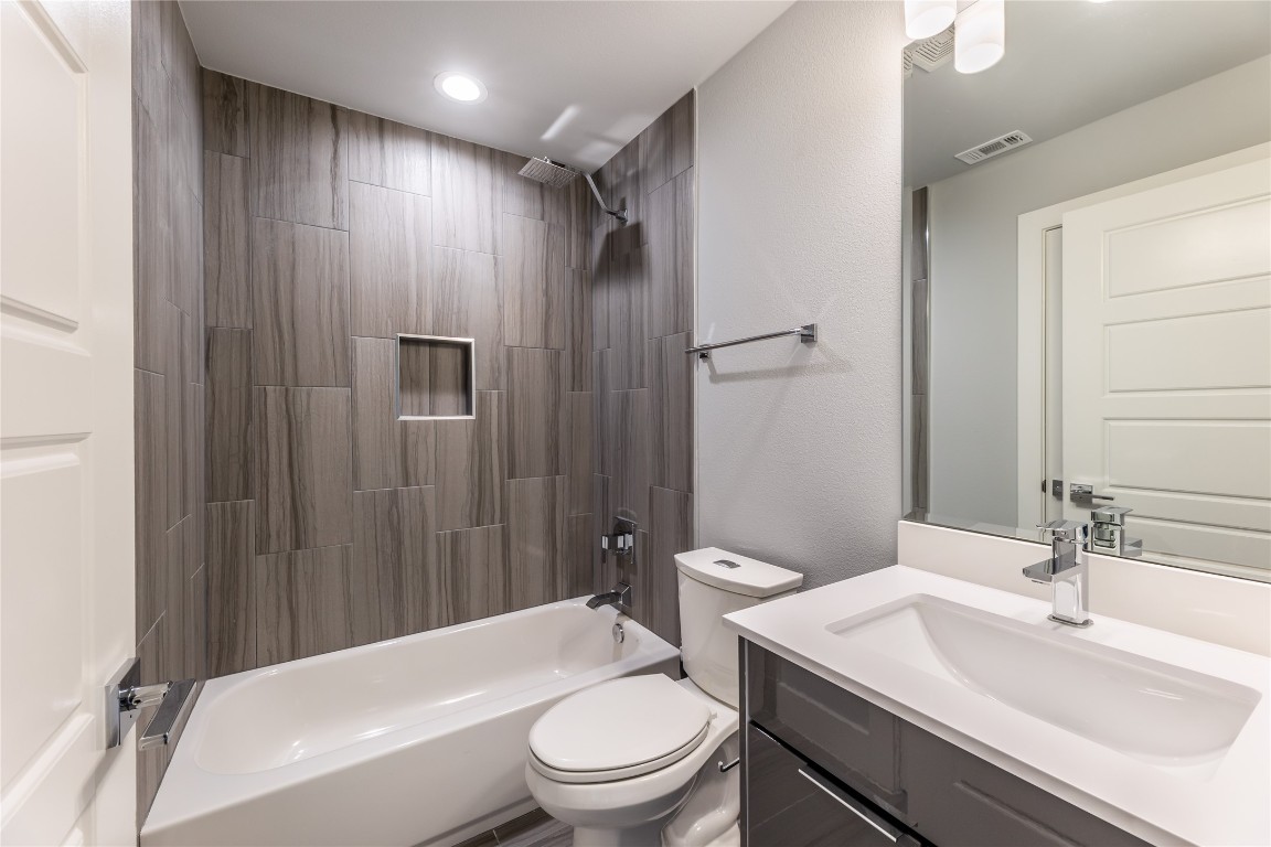 1417 Kramer Lane, Unit 9 Austin, TX 78758 - Photo 40 of 40 a bathroom with a sink a toilet and shower