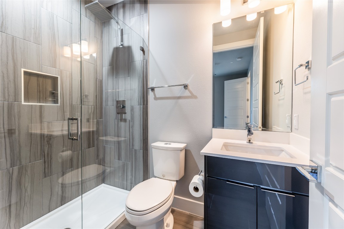 1417 Kramer Lane, Unit 9 Austin, TX 78758 - Photo 9 of 40 a bathroom with a sink toilet and shower