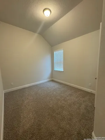 an empty room with a empty space and windows