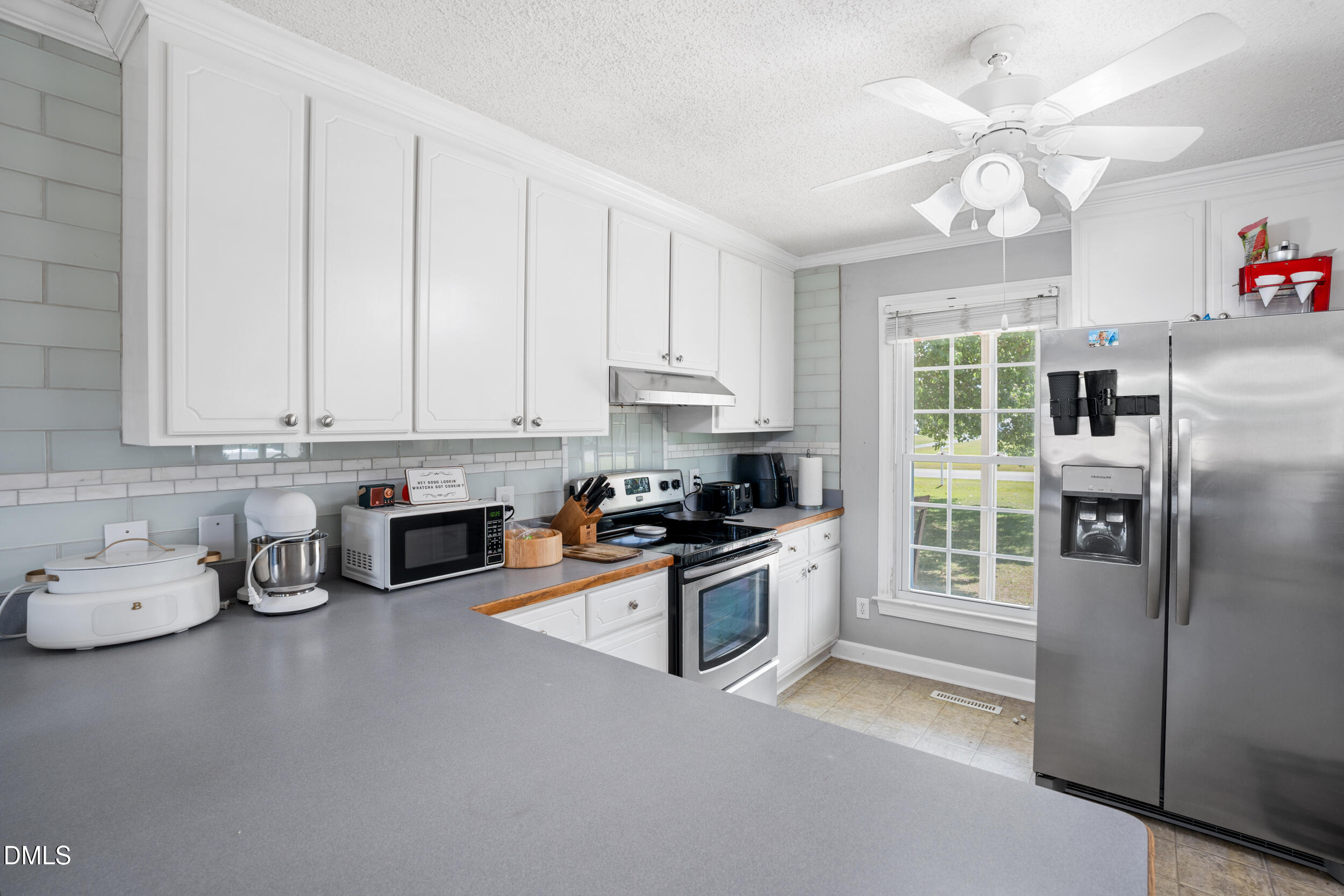 311 Bridgers Road Kenly, NC 27542 - Photo 9 of 46 a kitchen with stainless steel appliances granite countertop a refrigerator sink and stove top oven
