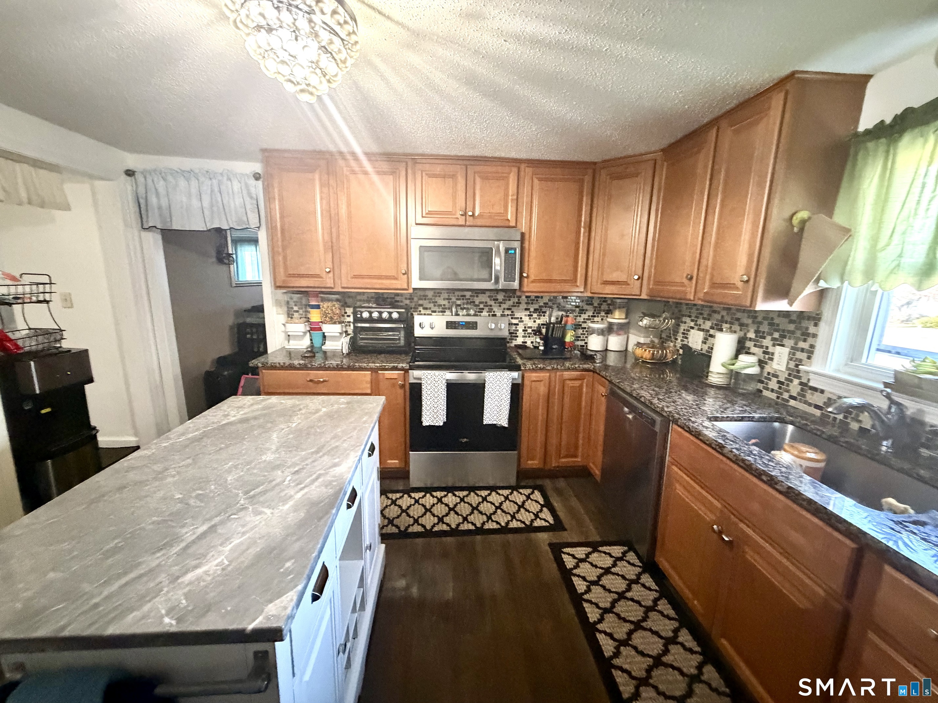 75 Elizabeth Avenue Bloomfield, CT 06002 - Photo 12 of 17 a kitchen with granite countertop a stove a sink dishwasher and a refrigerator