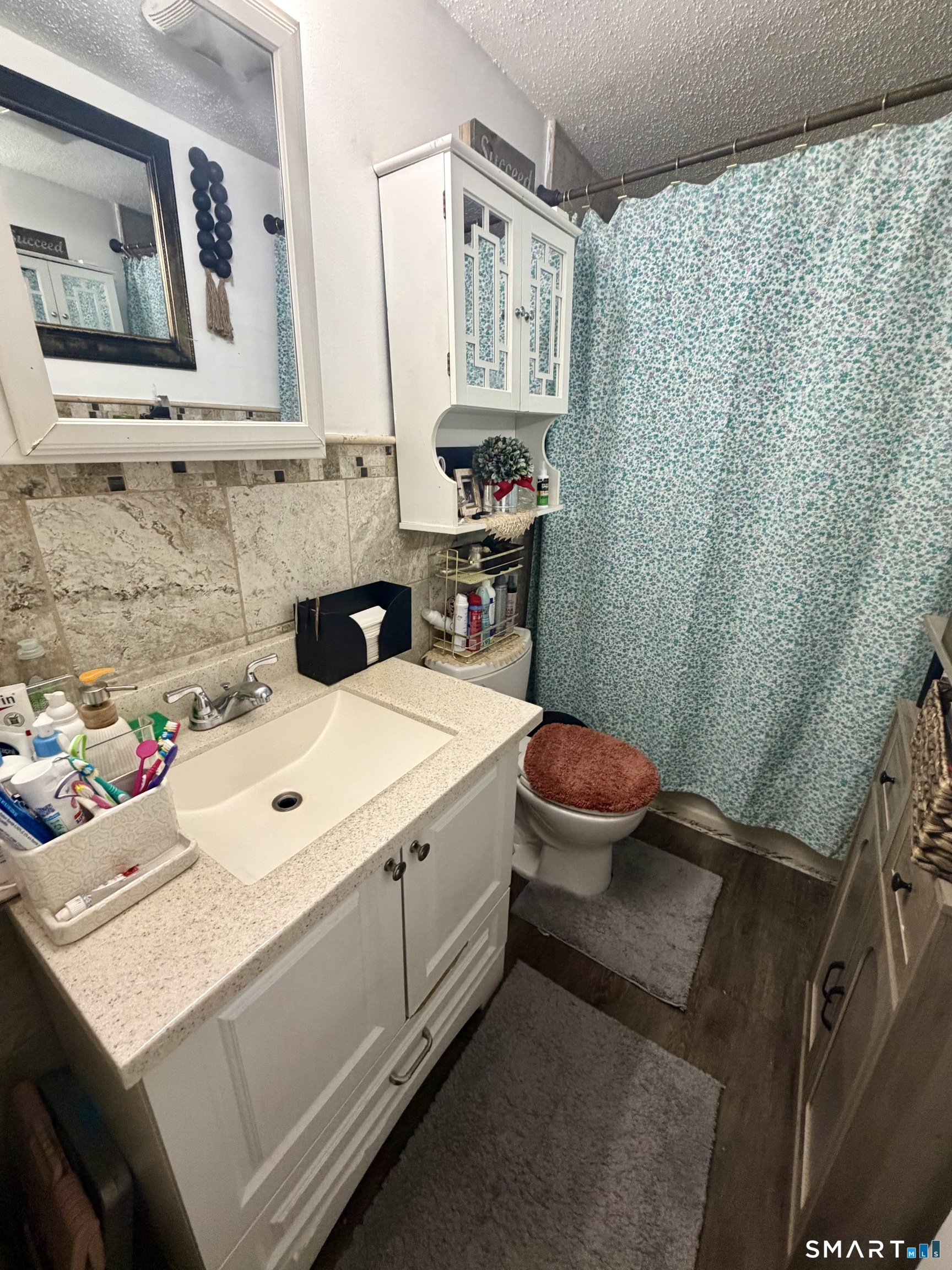 75 Elizabeth Avenue Bloomfield, CT 06002 - Photo 13 of 17 a bathroom with a sink and a mirror