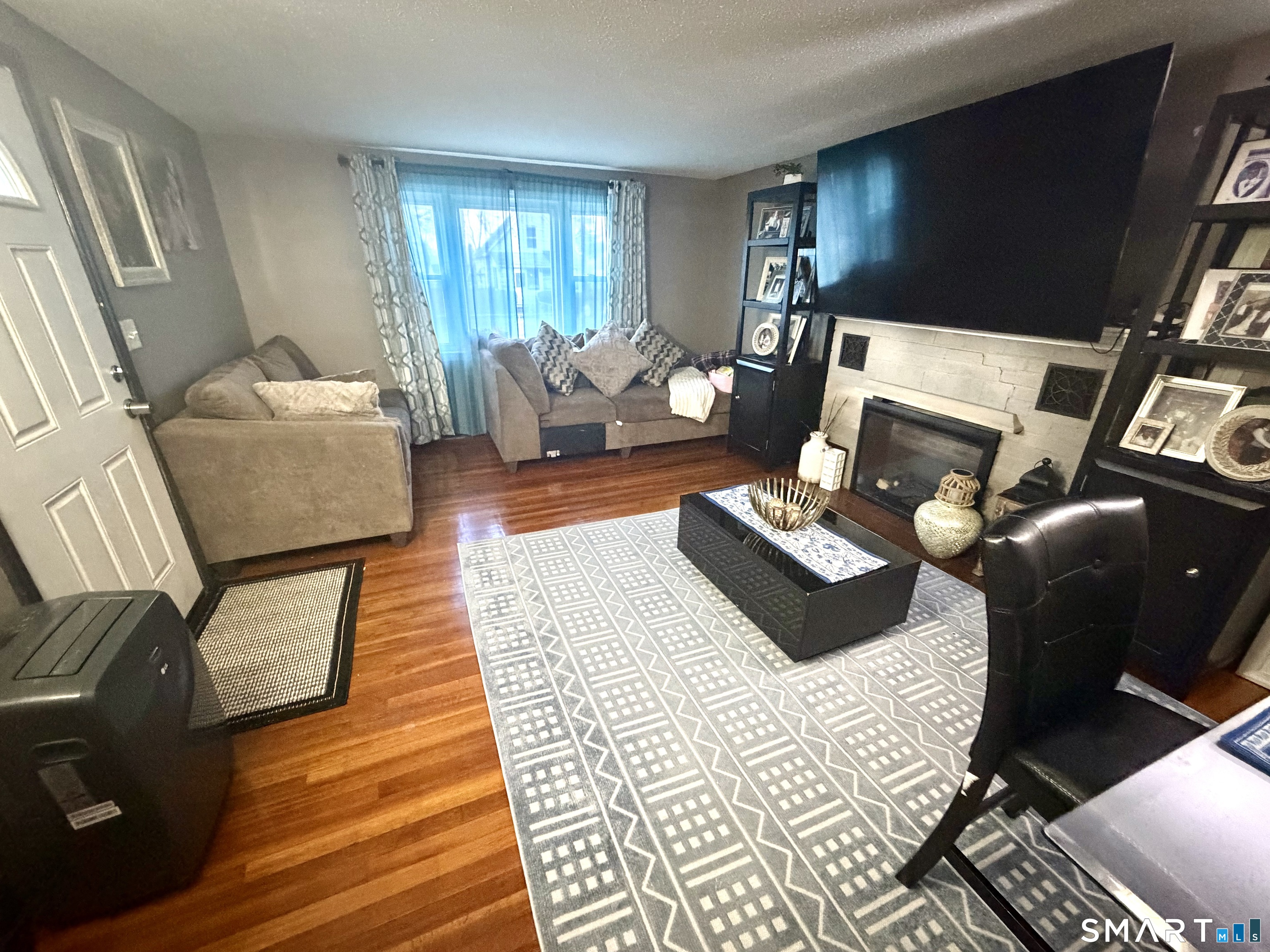 75 Elizabeth Avenue Bloomfield, CT 06002 - Photo 2 of 17 a living room with furniture and a flat screen tv