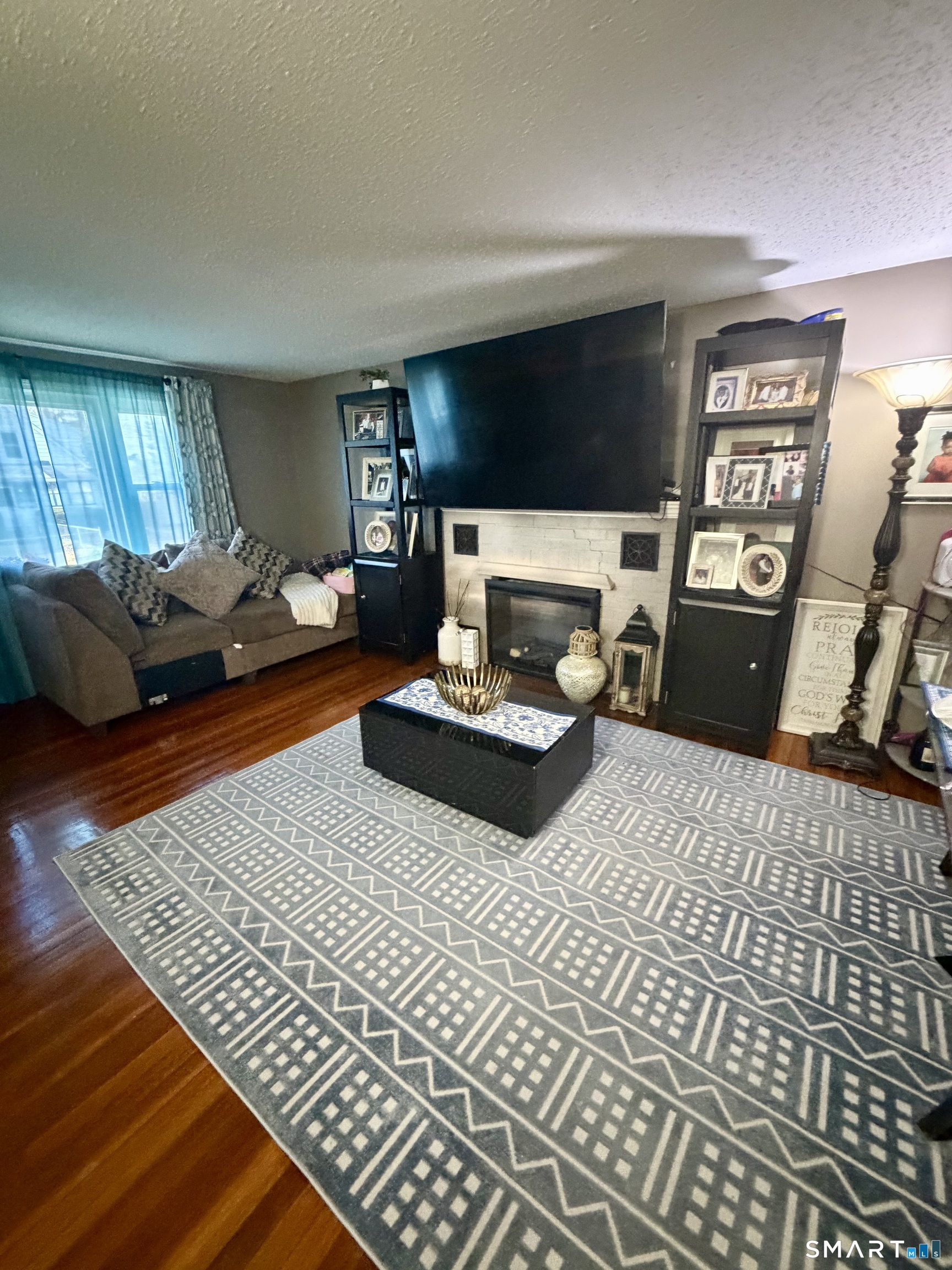 75 Elizabeth Avenue Bloomfield, CT 06002 - Photo 4 of 17 a living room with furniture and a flat screen tv
