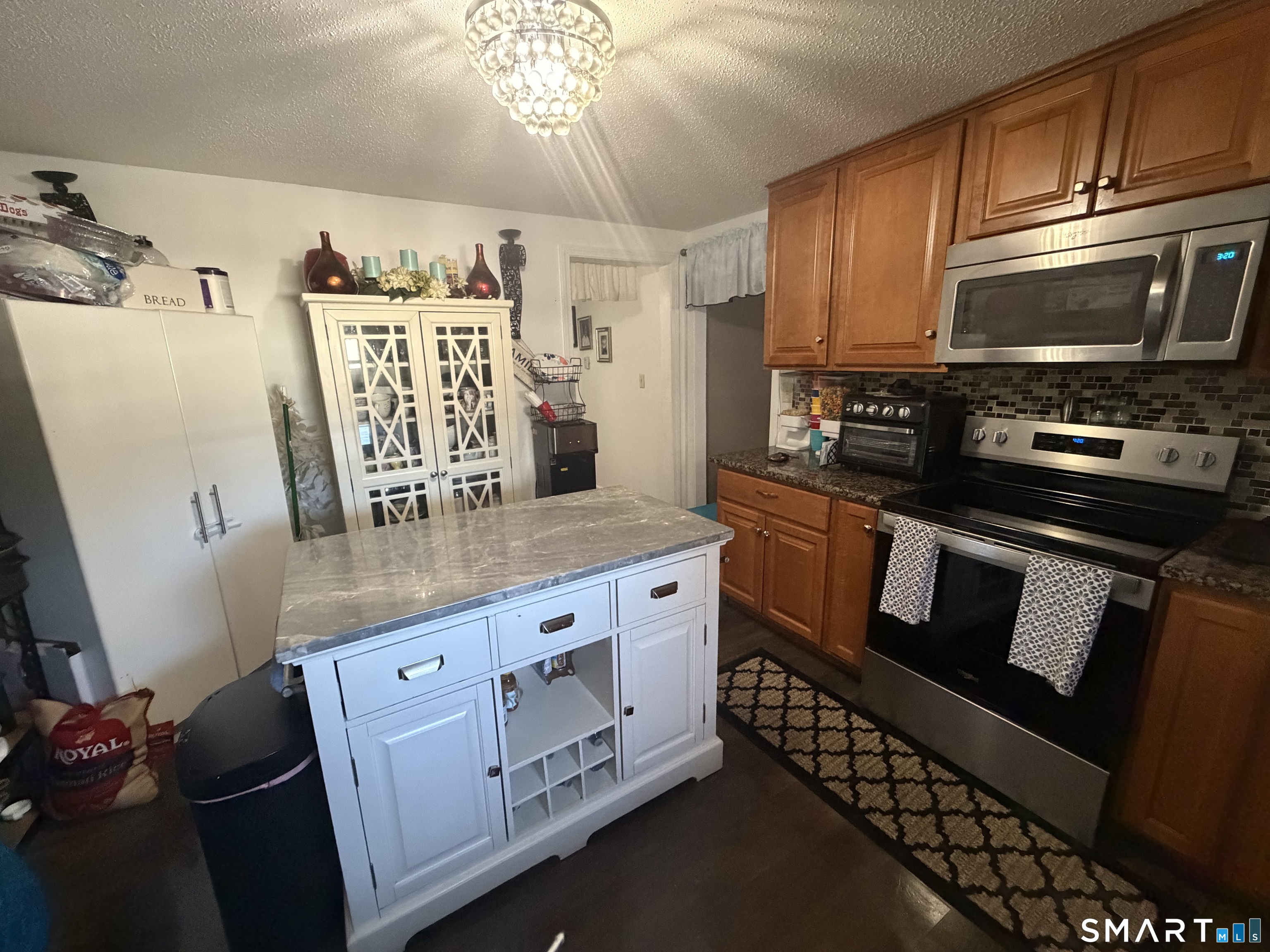 75 Elizabeth Avenue Bloomfield, CT 06002 - Photo 7 of 17 a kitchen with stainless steel appliances kitchen island granite countertop a refrigerator stove and sink