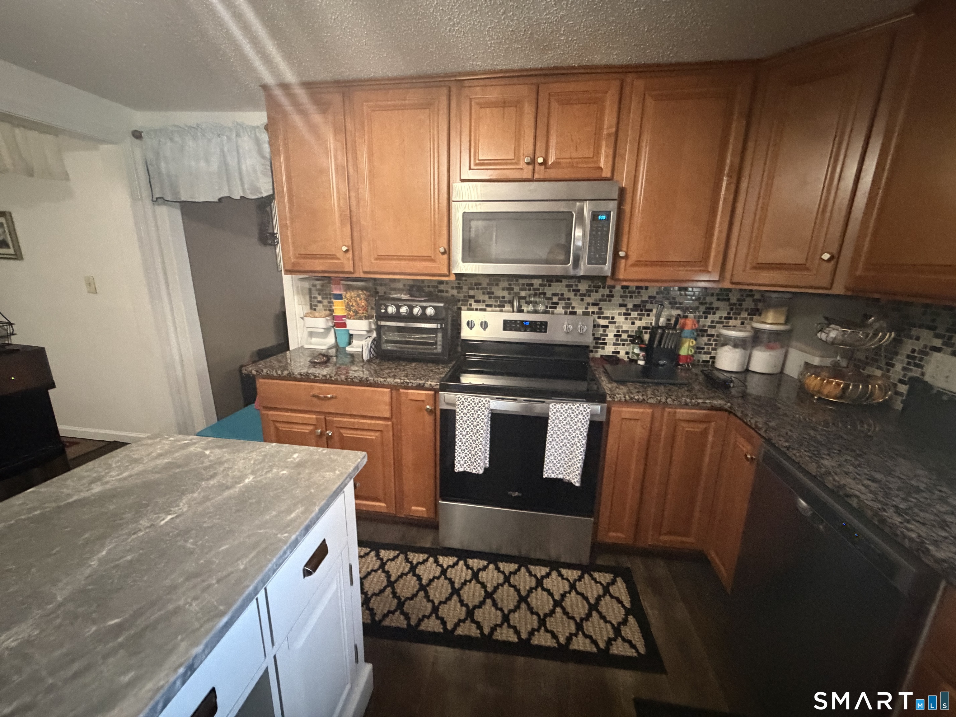 75 Elizabeth Avenue Bloomfield, CT 06002 - Photo 9 of 17 a kitchen with stainless steel appliances granite countertop a stove a sink dishwasher and a refrigerator