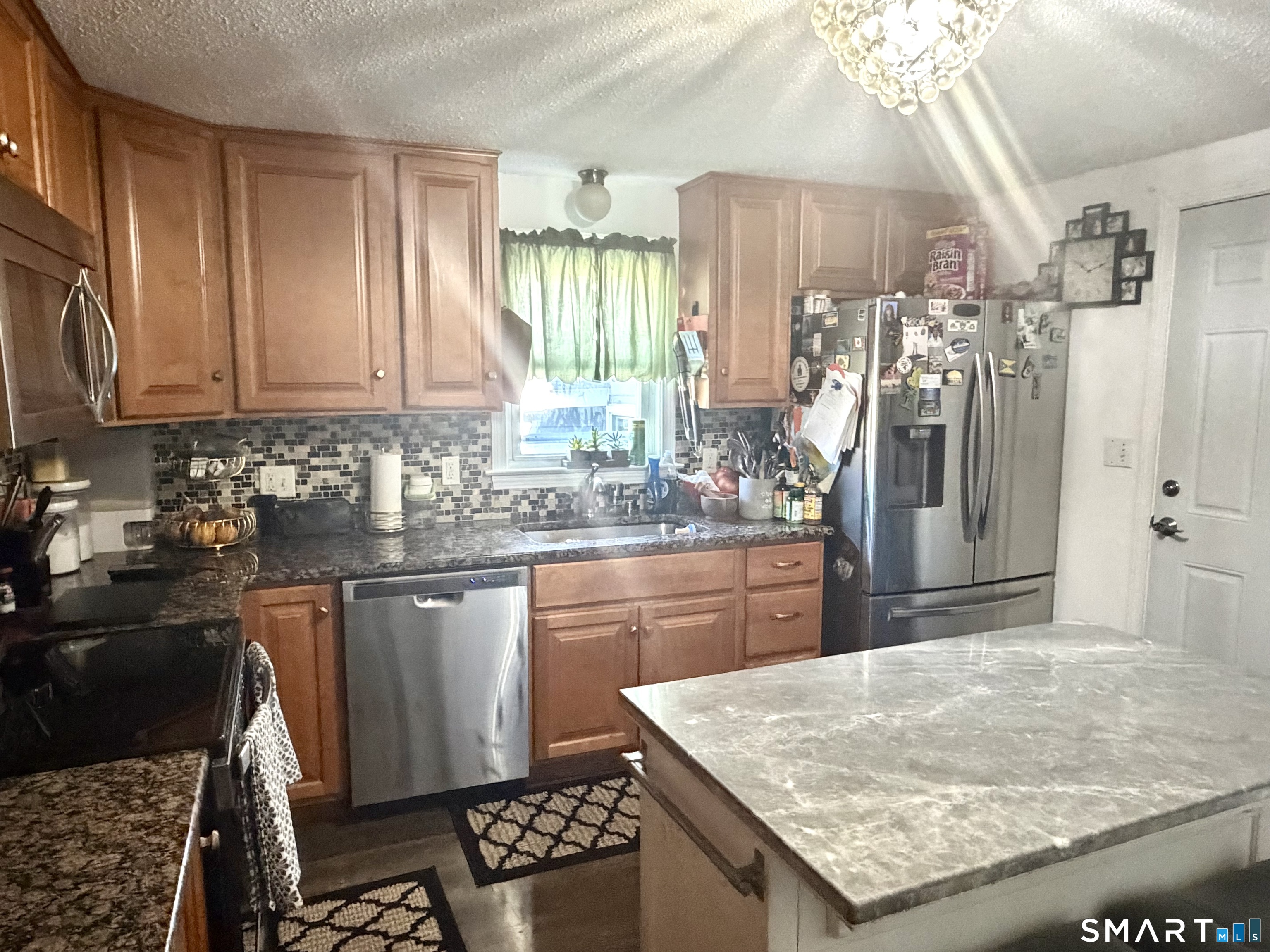 75 Elizabeth Avenue Bloomfield, CT 06002 - Photo 10 of 17 a kitchen with stainless steel appliances granite countertop a sink stove and refrigerator