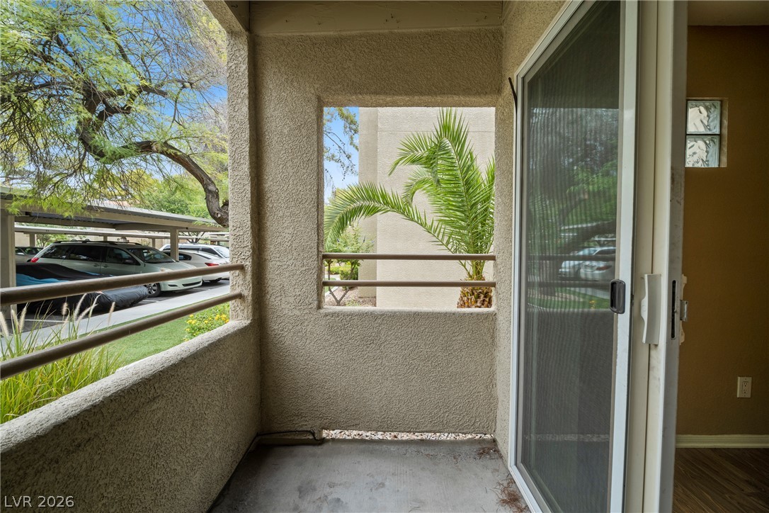 3145 East Flamingo Road, Unit 1055 Las Vegas, NV 89121 - Photo 35 of 40 Enjoy outdoor living on this private balcony, offering serene views of the surrounding greenery and convenient covered parking.