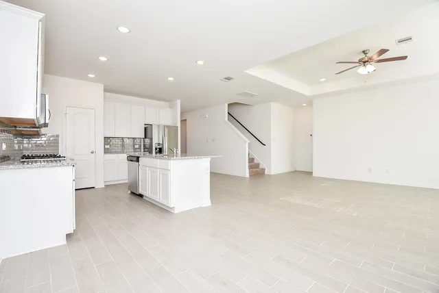 a view of kitchen with furniture and stainless steel appliances