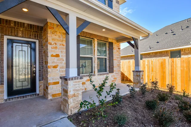 a front view of a house with outdoor seating and plants