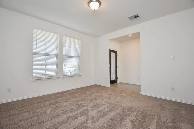 a view of an empty room with a window