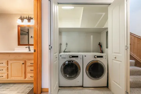 a view of a hallway with washer and dryer