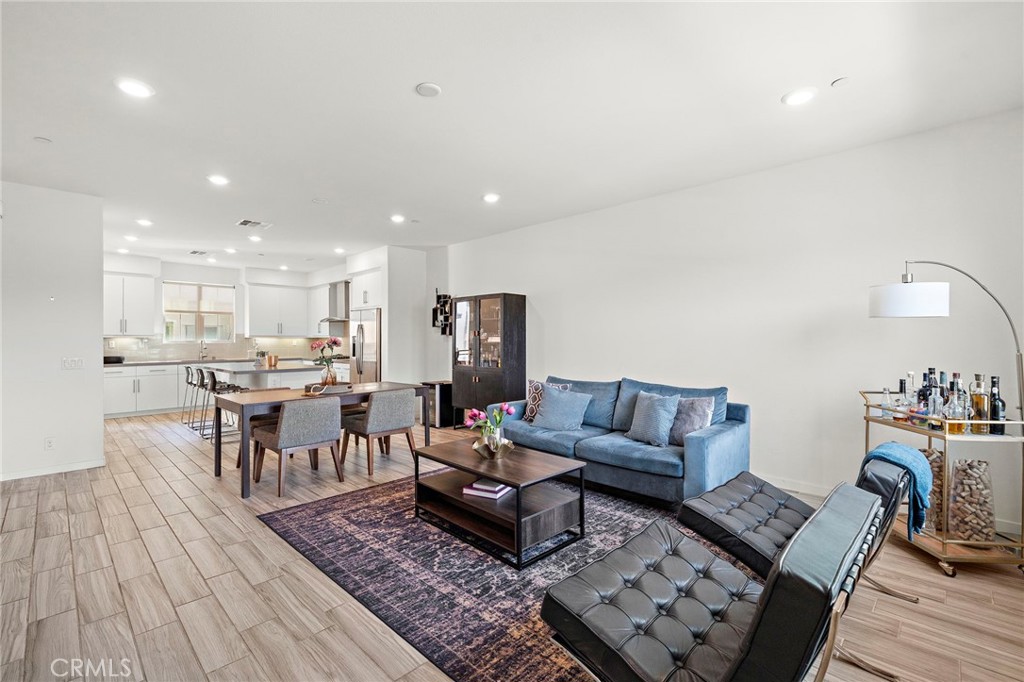144 Paramount Irvine, CA 92618 - Photo 10 of 43 a living room with furniture and wooden floor