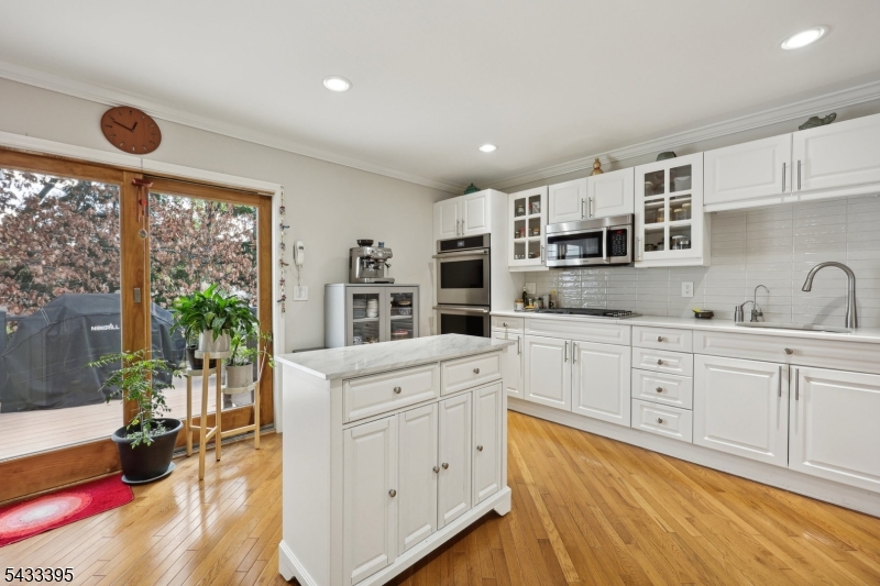 48 Woodmont Road Montclair, NJ 07043 - Photo 7 of 20 a kitchen with cabinets appliances and a large window