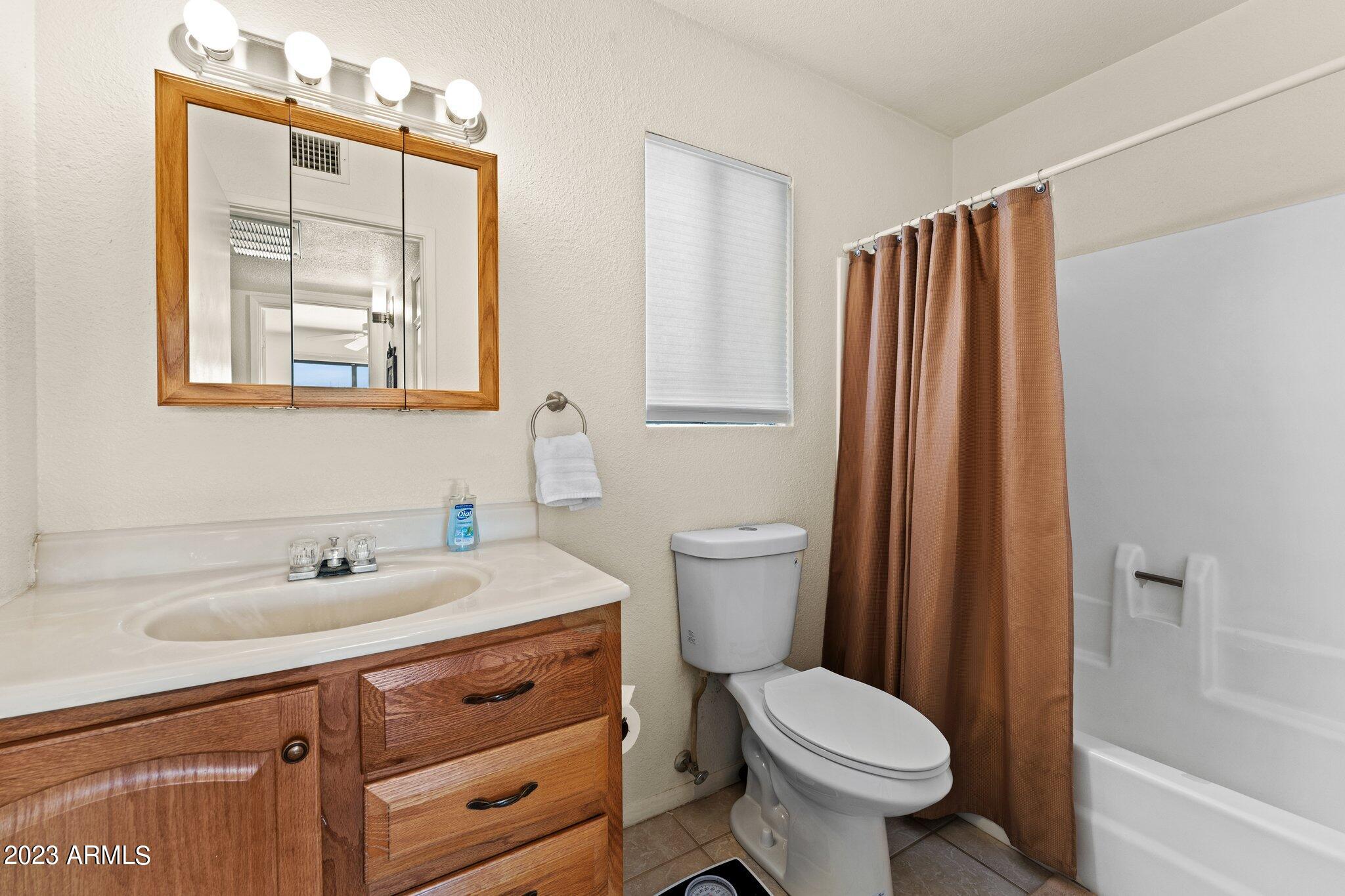 540 South West Road, Unit 26 Wickenburg, AZ 85390 - Photo 6 of 14 a bathroom with a sink toilet and shower