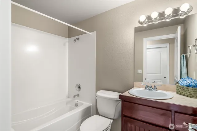 a bathroom with a sink vanity mirror and toilet