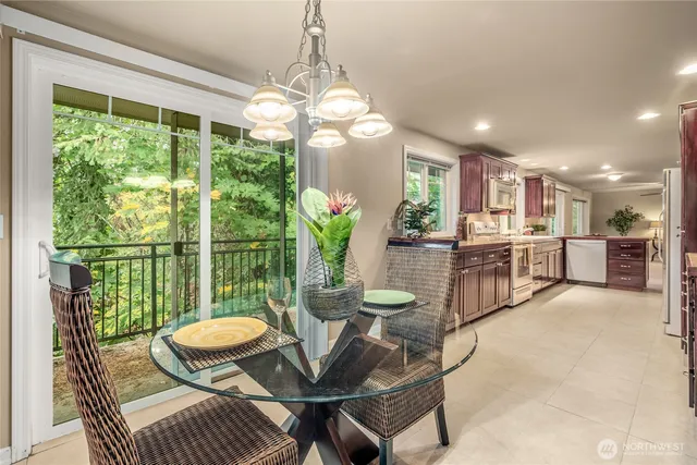 a view of a dining room with furniture a chandelier and wooden floor
