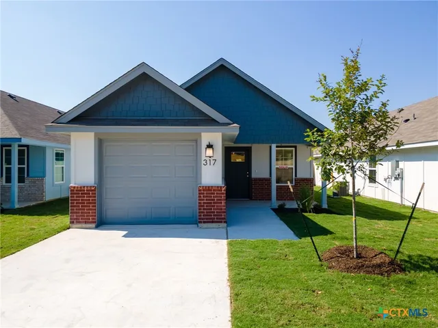 a backyard of a house with plants and garden