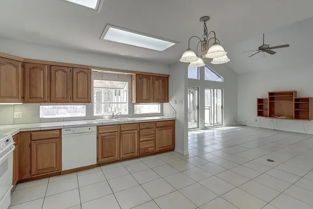 a spacious bathroom with a granite countertop sink a mirror and a shower