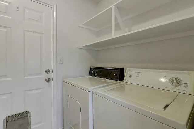a view of an empty room with cabinet and a window