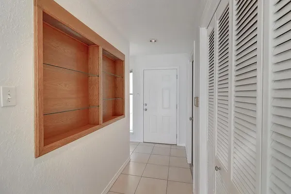 a view of an empty room with a fireplace and a window