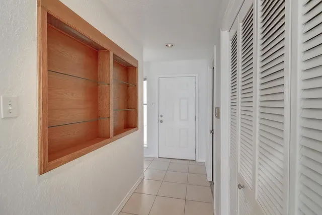 a view of an empty room with a fireplace and a window