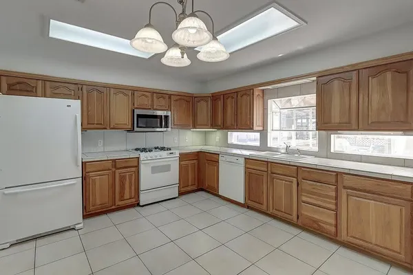 a kitchen with a sink stove and refrigerator