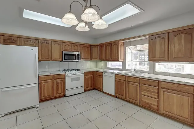 a kitchen with a sink stove and refrigerator