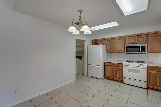 a large kitchen with cabinets and wooden floor
