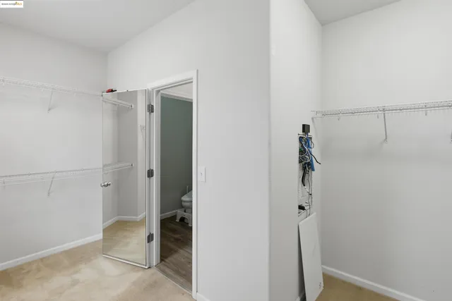 a white toilet sitting next to a window