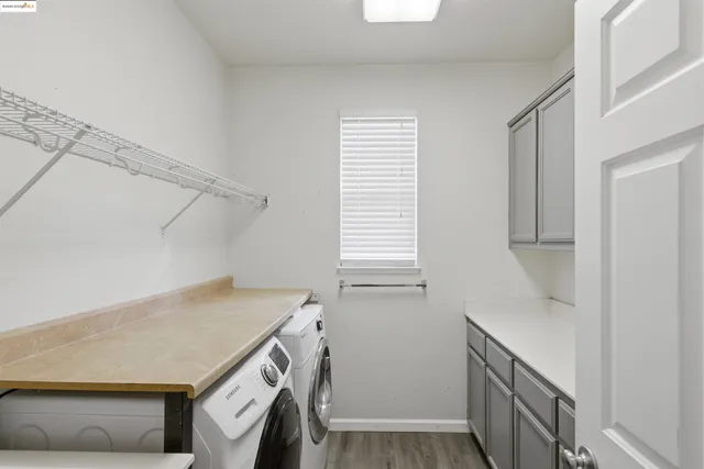 a view of a backyard with table and chairs under an umbrella