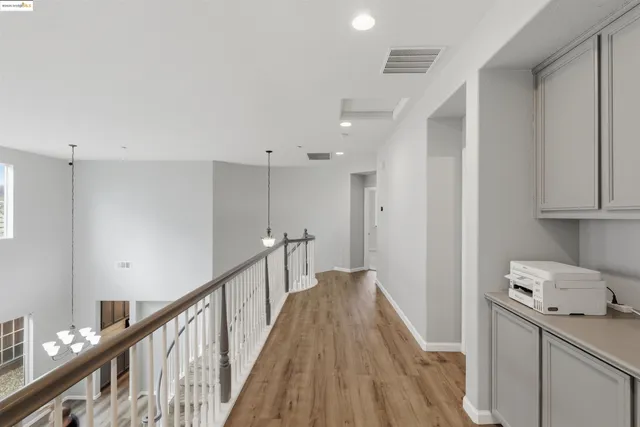 a kitchen with a sink refrigerator and cabinets