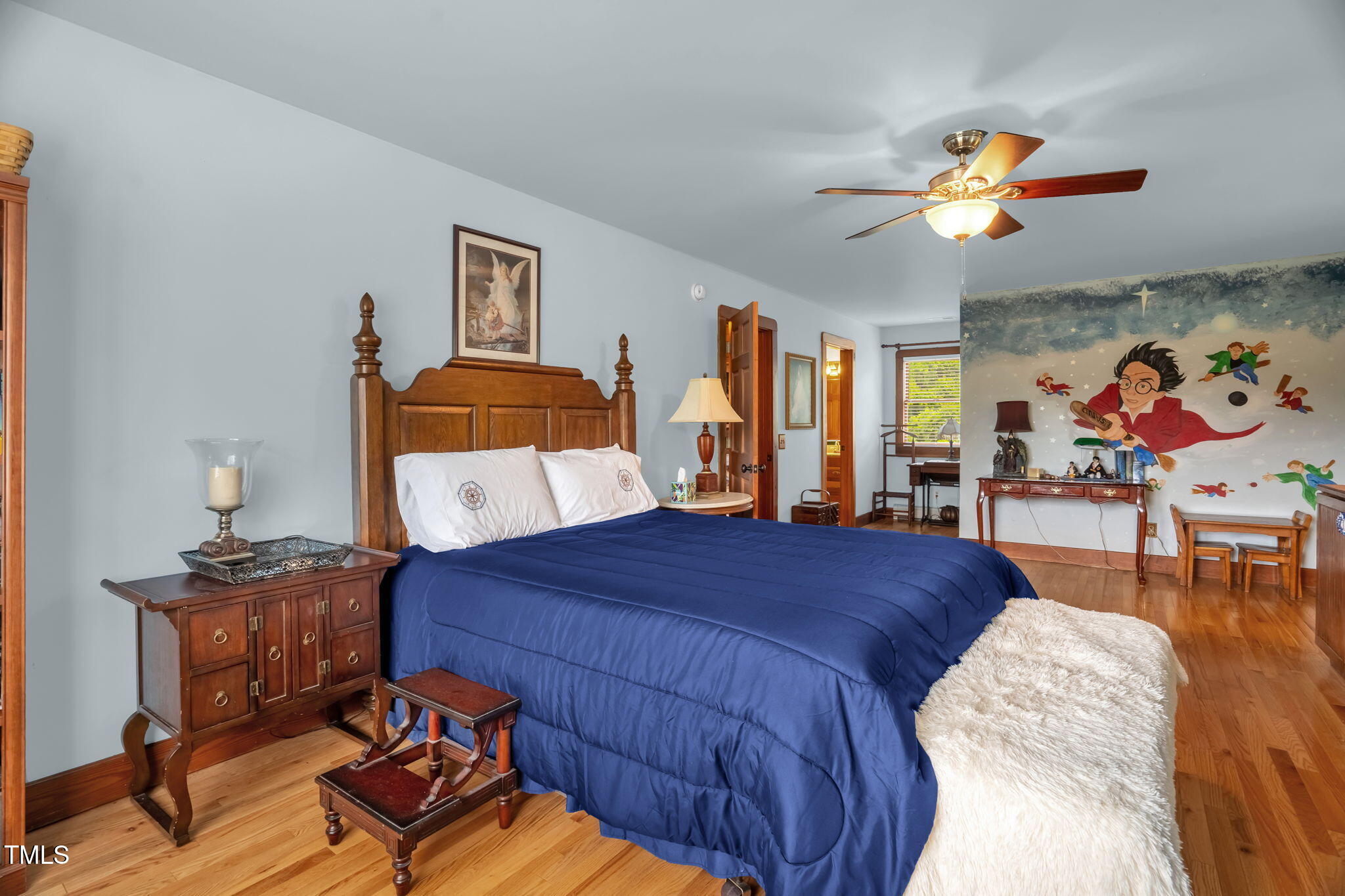 771 Cedar Grove Church Road Roxboro, NC 27574 - Photo 33 of 45 a bedroom with a bed and wooden floor