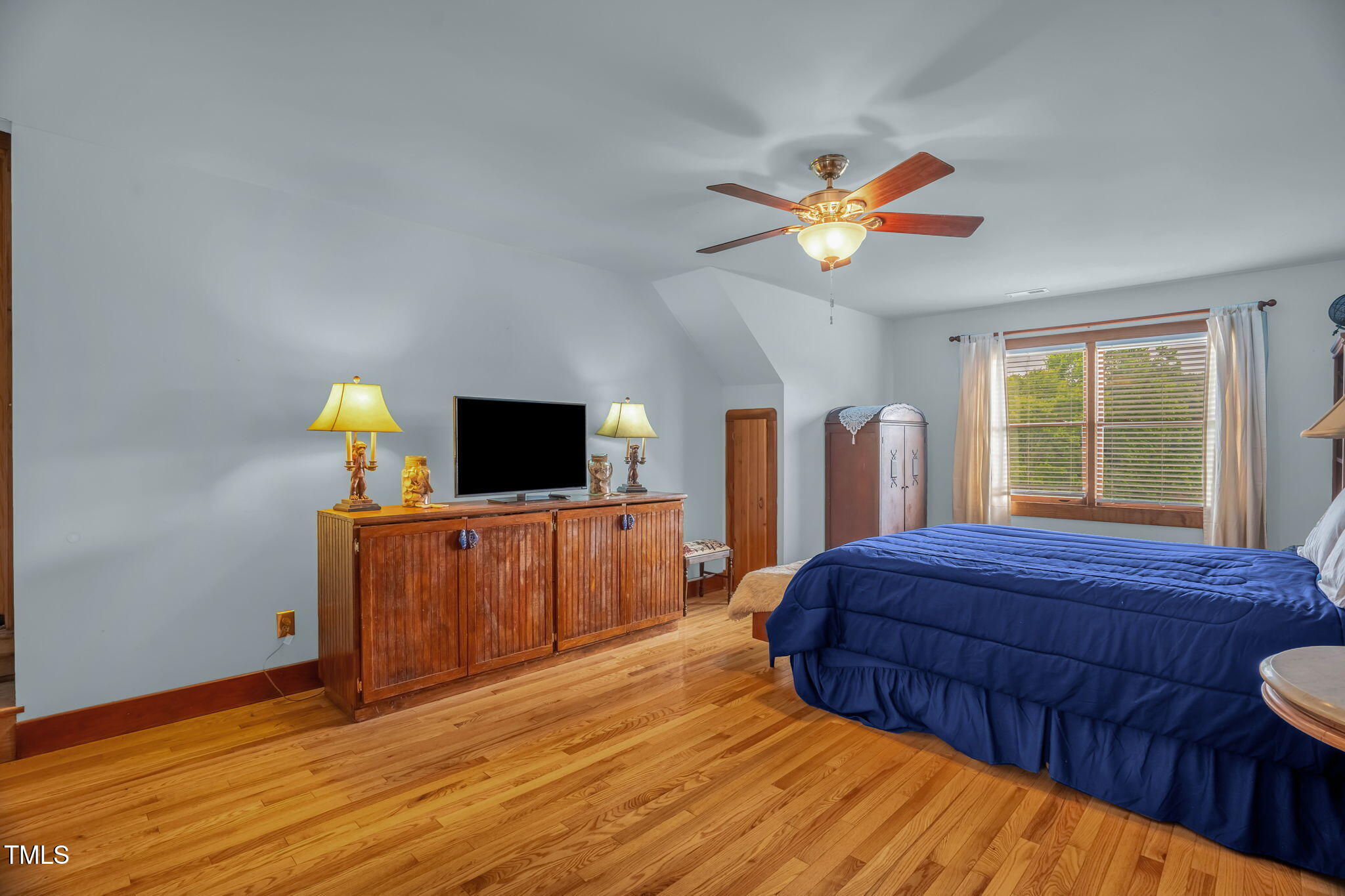 771 Cedar Grove Church Road Roxboro, NC 27574 - Photo 34 of 45 a bedroom with a bed and a chandelier