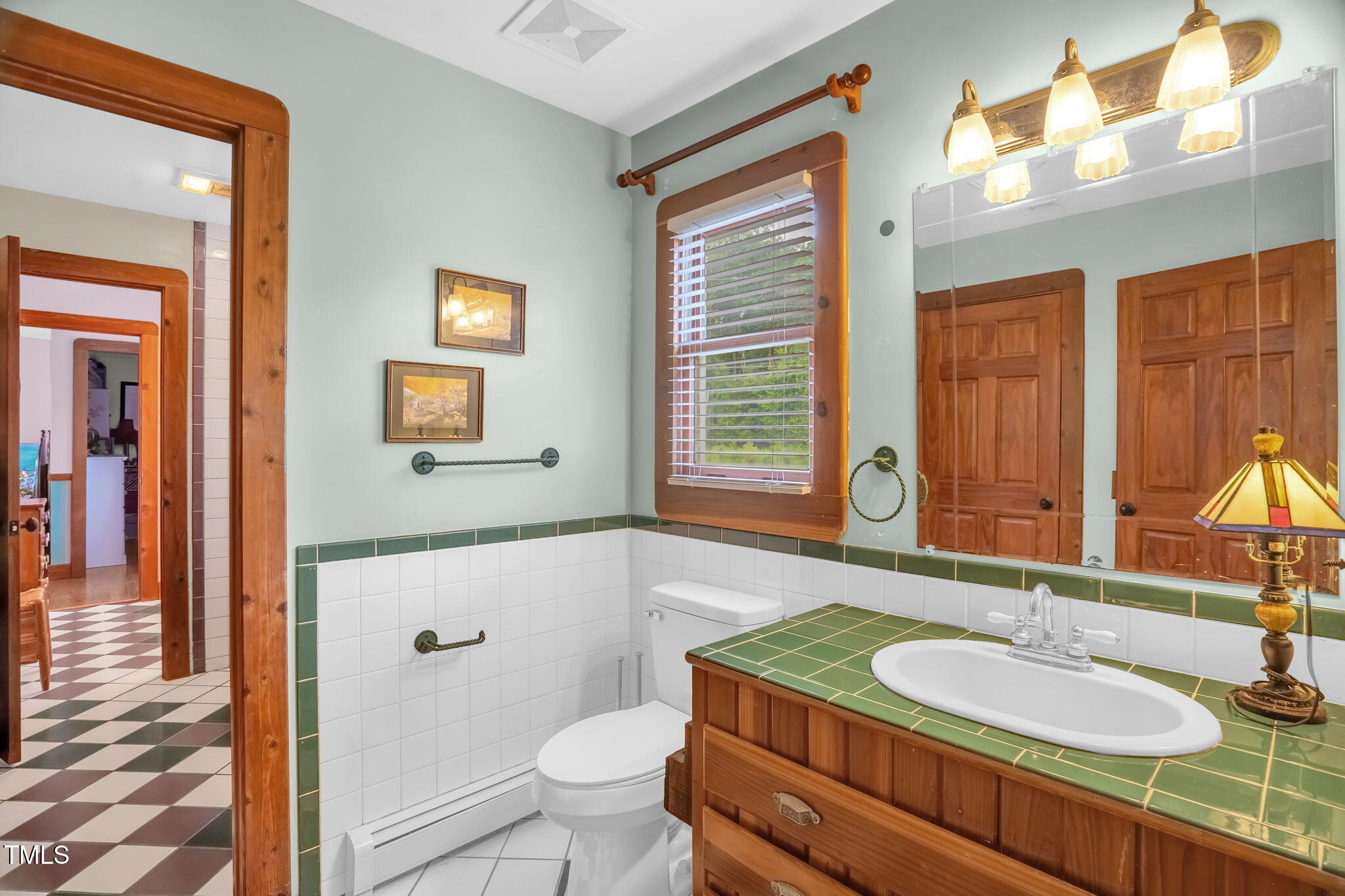 771 Cedar Grove Church Road Roxboro, NC 27574 - Photo 39 of 45 a bathroom with a granite countertop sink a toilet a mirror and shower