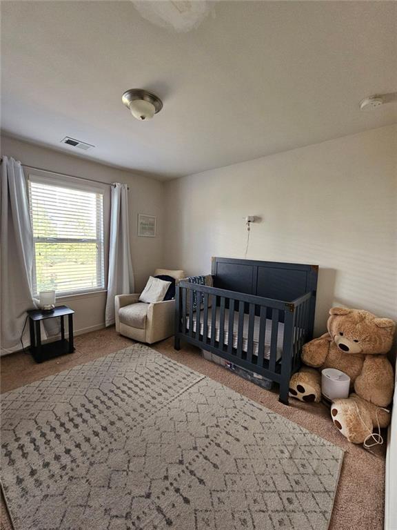 5747 Radford Loop Fairburn, GA 30213 - Photo 18 of 36 a bedroom with furniture and a window
