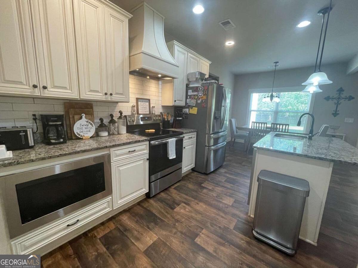 457 Old Good Hope Road Good Hope, GA 30641 - Photo 18 of 59 a kitchen with stainless steel appliances granite countertop a stove a sink and a microwave