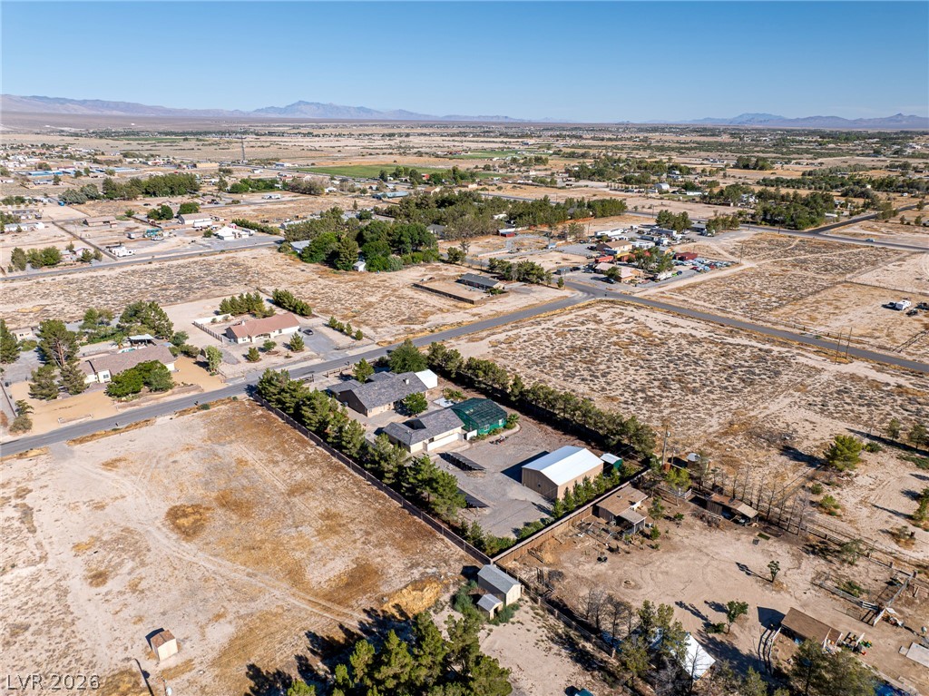 3780 South Ranger Way Pahrump, NV 89048 - Photo 56 of 57 An aerial perspective showcases a large rural property with surrounding desert landscape and distant mountains.