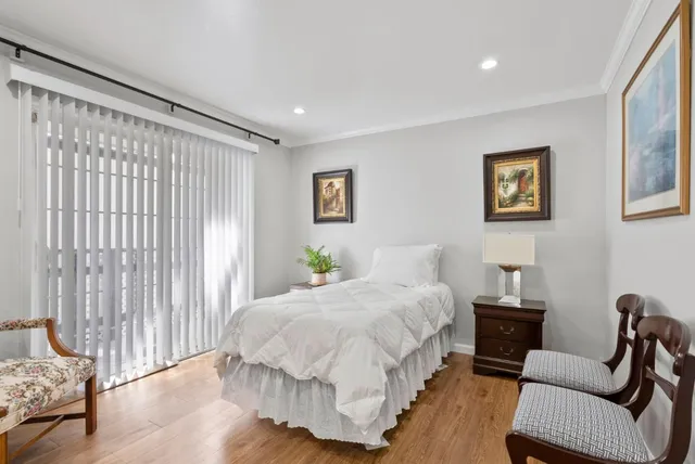 a spacious bedroom with a bed and a couch