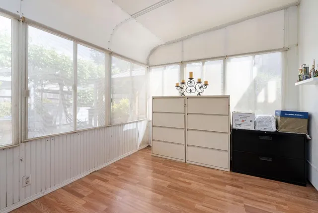a room with a window and cabinet