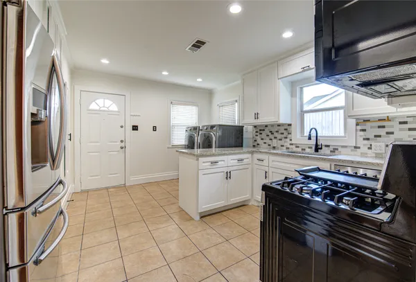 a kitchen with a stove and a refrigerator