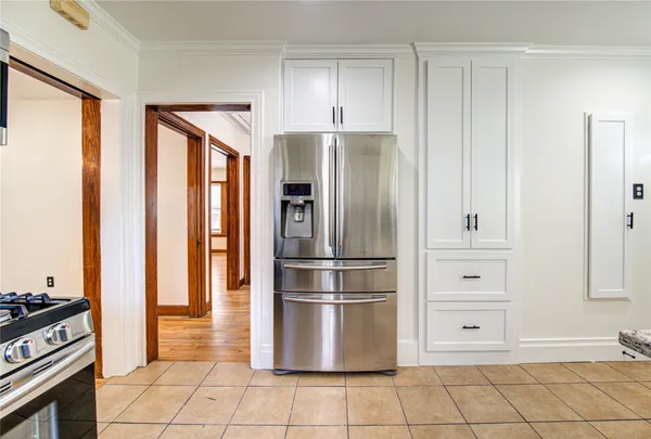 a kitchen with stainless steel appliances granite countertop a refrigerator and a stove