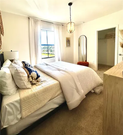 a bedroom with bed and window