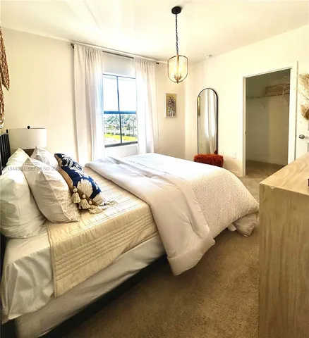 a bedroom with bed and window