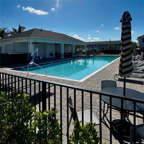 a view of a balcony with two chairs and a table