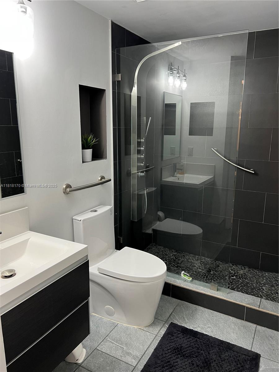 Flagami Miami, FL 33126 - Photo 4 of 8 a bathroom with a toilet a sink and mirror