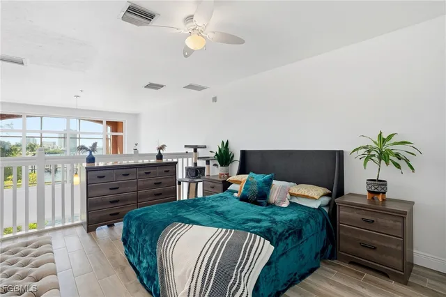 a bedroom with a bed and a flat tv screen